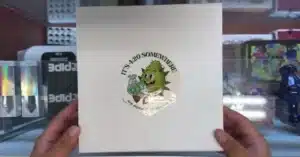 Emerald Smoke 99 dollar oz package contents showing flower, lab results, and bonus items